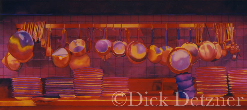 pots and pans hanging on a wall with strong red glow